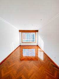 Low angle view of empty wooden floor in building
