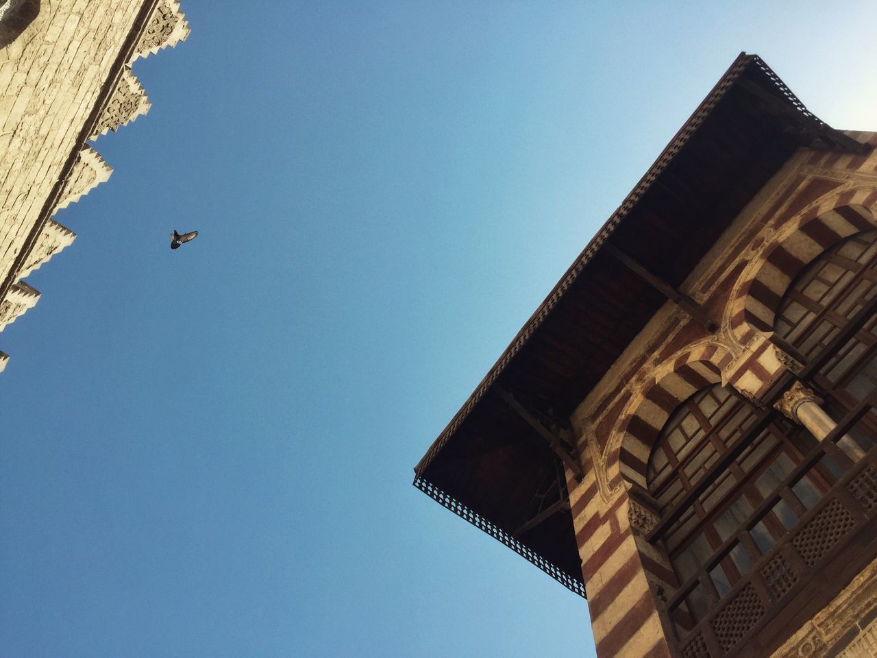 low angle view, built structure, building exterior, architecture, sky, clear sky, blue, day, outdoors, no people