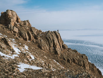 Rock formations in sea against sky