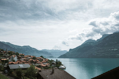 Scenic view of sea by buildings against sky