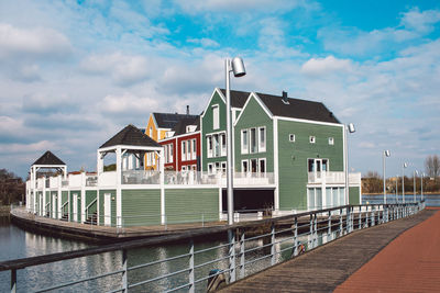 Building by river against sky