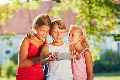 Children taking selfie with mobile phone