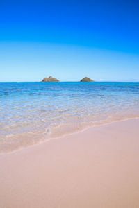 Scenic view of sea against clear blue sky