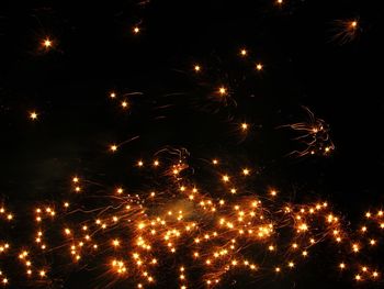 Low angle view of firework display at night