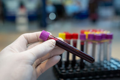 Cropped hand of person holding thermometer