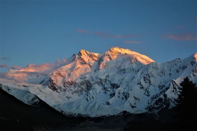 Scenic view of snowcapped mountains against sky during sunset