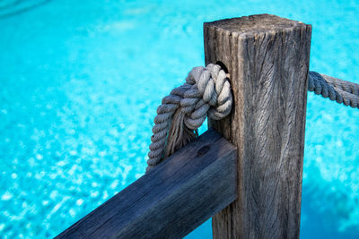 Close-up of rope tied on wooden post