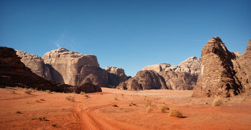 Scenic view of rocky mountains against clear blue sky