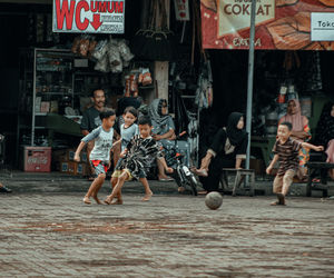 Boy playing soccer with his partner