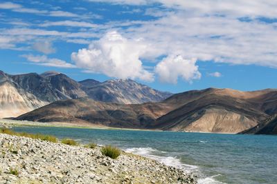 Scenic view of mountains against cloudy sky