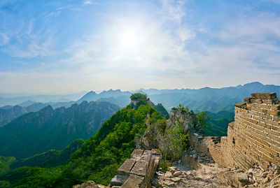 Scenic view of mountains against cloudy sky