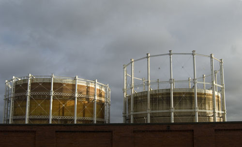 Low angle view of building against cloudy sky