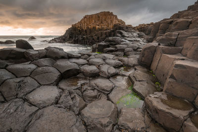 Giants causeway against cloudy sky