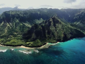 Scenic view of sea and mountains against sky