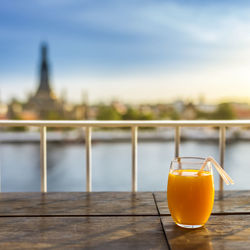 Close-up of drink on table against sky