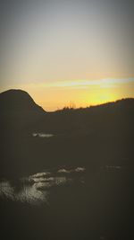 Scenic view of mountains against sky at sunset