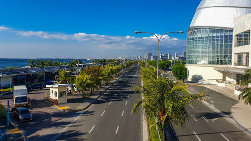 Street amidst buildings against blue sky