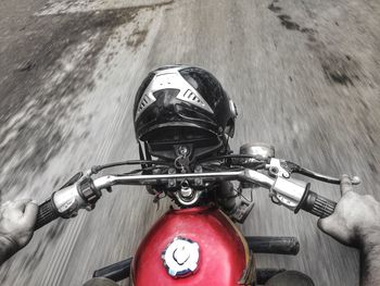 Close-up of man riding bicycle on road