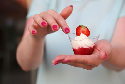 Close-up of hand holding dessert