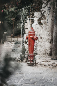 Red fire hydrant on footpath during winter