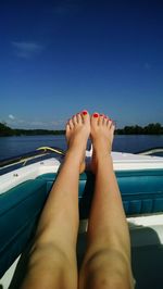 Low section of woman relaxing in water