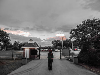 Silhouette of woman against cloudy sky