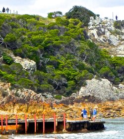 Tourists sitting on rock
