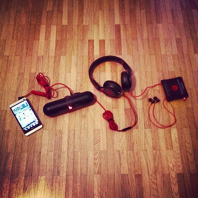 indoors, table, still life, technology, wood - material, communication, high angle view, music, close-up, connection, hardwood floor, single object, arts culture and entertainment, old-fashioned, musical instrument, retro styled, no people, wireless technology, home interior, equipment