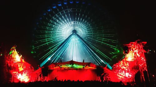 Low angle view of illuminated ferris wheel