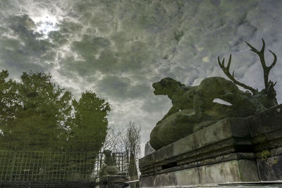 Low angle view of statue against sky