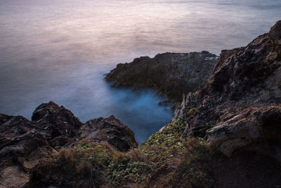 High angle view of rock formations at seaside