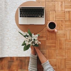 Low section of woman holding coffee cup