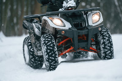 Close-up of car on snow covered field