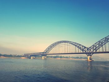 Bridge over river against clear sky