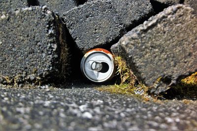 Close-up of can amidst rock