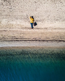 Rear view of man surfing in sea