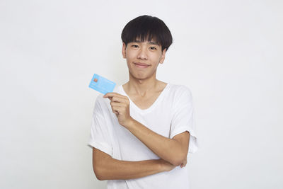 Portrait of a smiling young man against white background