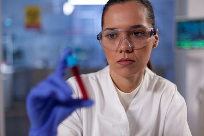 Doctor holding blood sample in laboratory