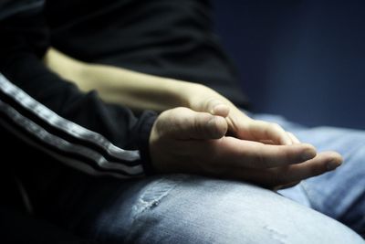 Low section of man sitting on floor
