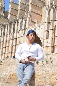 Low angle view of young man using mobile phone