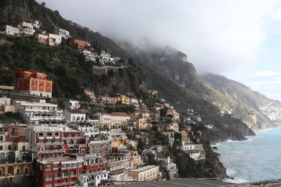 High angle view of townscape by sea against sky