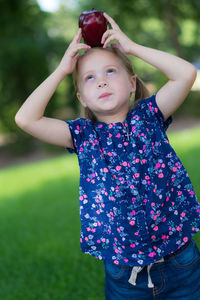 Portrait of girl playing on grass