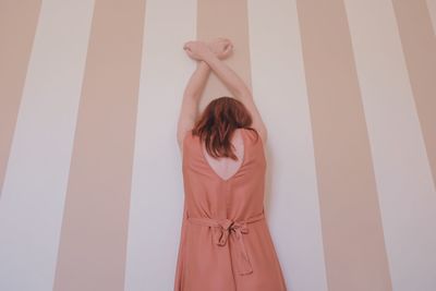 Woman standing against wall