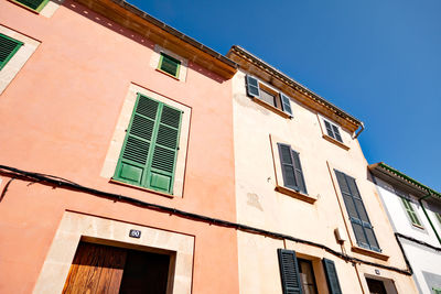 Low angle view of residential building against blue sky