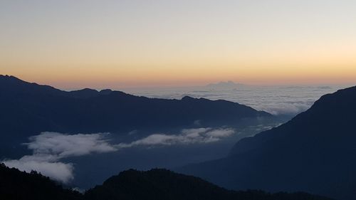 Scenic view of silhouette mountains against sky during sunset