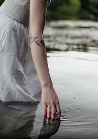 Low section of woman legs in water