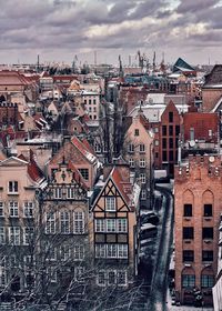 High angle view of buildings against cloudy sky