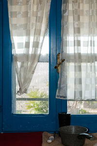 Clothes hanging on glass window at home