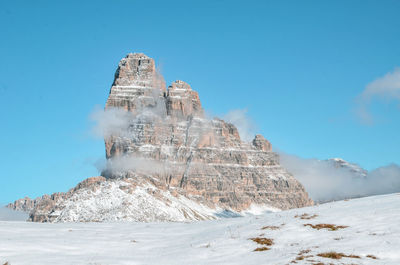 Scenic view of snowcapped mountain against blue sky