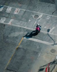 High angle view of man on vespa scooter in city
